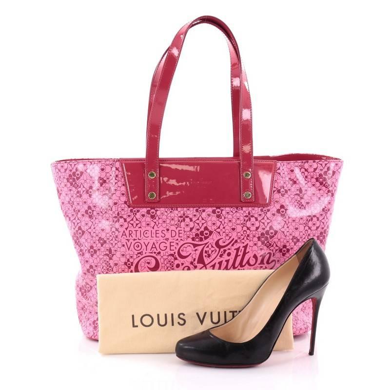 This authentic Louis Vuitton Voyage Tote Cosmic Blossom PM is a limited edition, unique piece that has a glossy and vibrant color. Crafted from pink patent leather with cosmic monogram flower prints created by Japanese artist Takashi Murakami, this