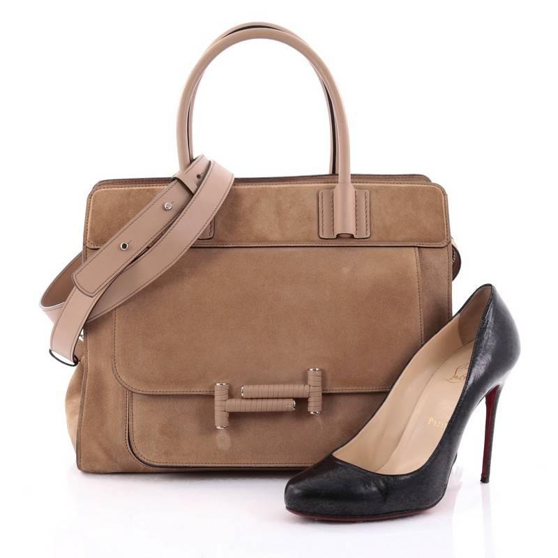 This authentic Tod's Double T Satchel Bag Suede Small is a chic and versatile bag perfect for everyday excursions. Crafted in light brown suede, this elegant bag features dual rolled leather handles, exterior front pocket with iconic Double T snap