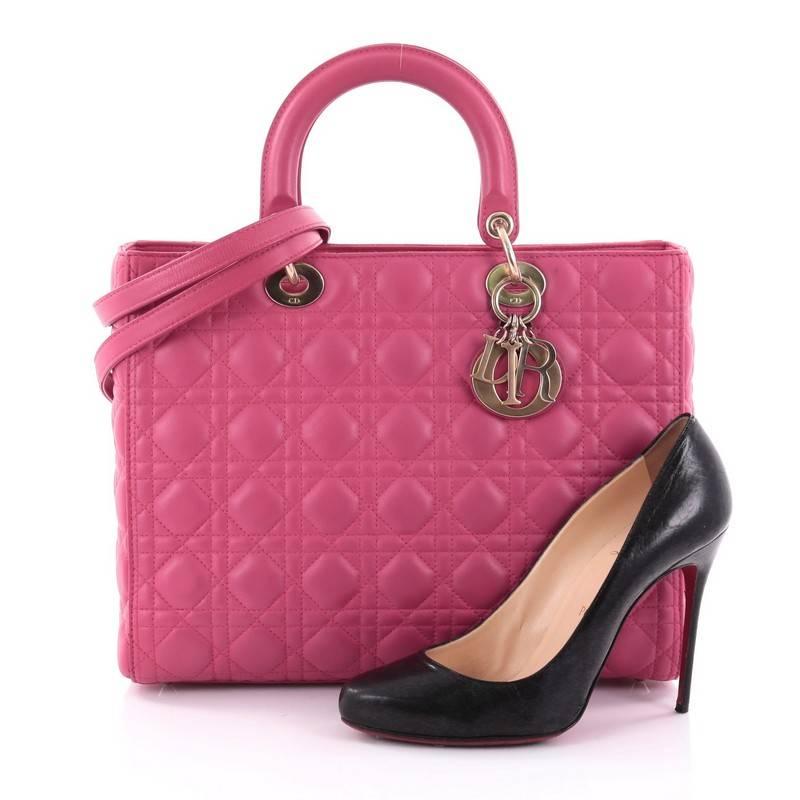 This authentic Christian Dior Lady Dior Handbag Cannage Quilt Lambskin Large is a classic staple that every fashionista needs in her wardrobe. Crafted from pink lambskin leather in Dior's iconic cannage quilting, this boxy bag features dual-rolled