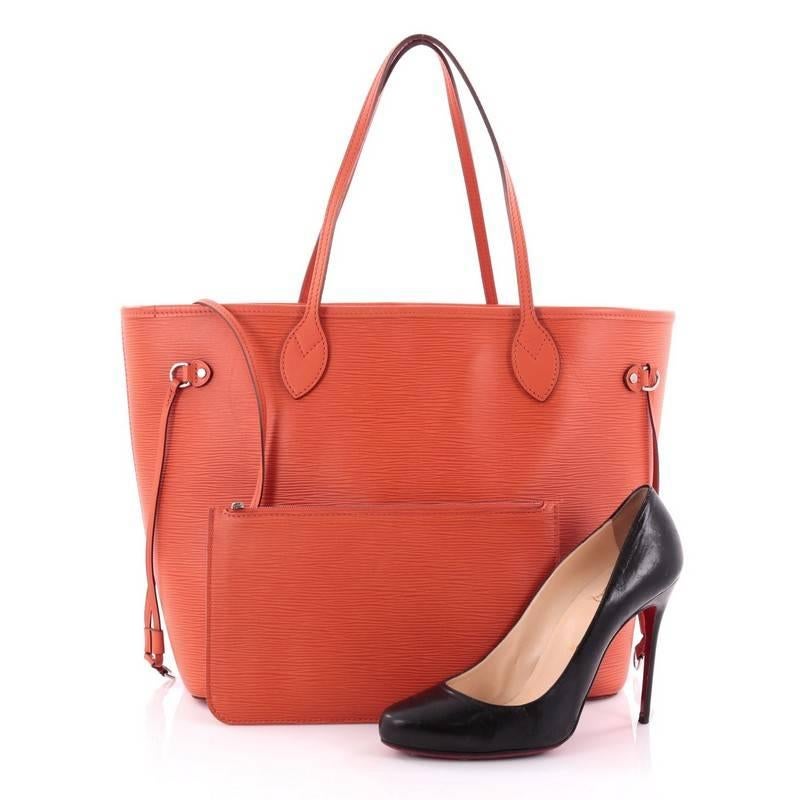 This authentic Louis Vuitton Neverfull Tote Epi Leather MM is a perfect companion for daily excursions. Crafted in orange epi leather, this iconic, easy-to-carry tote features dual flat leather handles, side tassels that cinches and expands and