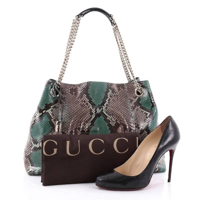 This authentic Gucci Soho Shoulder Bag Chain Strap Python Medium is simple yet stylish in design. Crafted from genuine green and taupe python skin, this hobo features gold chain strap with leather pads, fringe tassel, signature interlocking Gucci