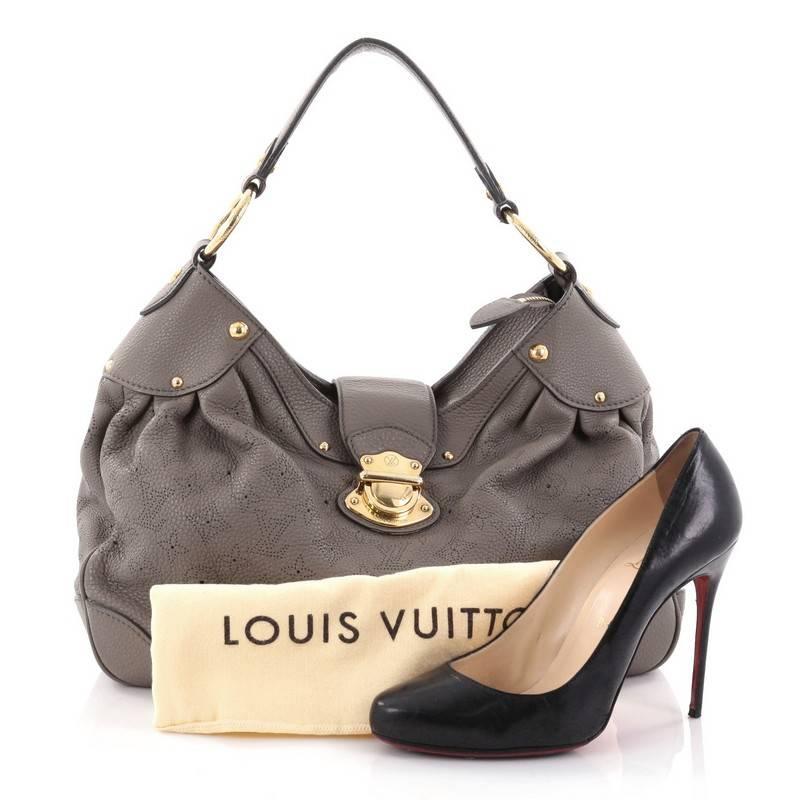 This authentic Louis Vuitton Solar Handbag Mahina Leather PM is an easy, feminine design constructed with intricate perforated monogram in taupe mahina leather. Showcased in the brand's Spring/ Summer 2010 Collection, this elegant and roomy hobo
