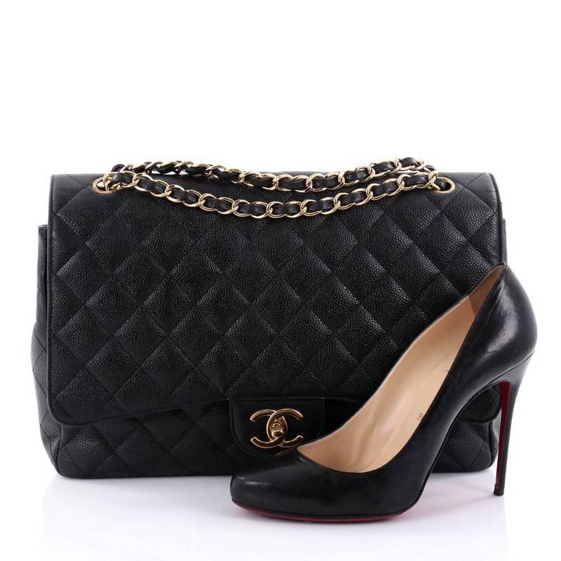 This authentic Chanel Classic Double Flap Bag Quilted Caviar Maxi exudes a classic yet easy style made for the modern woman. Crafted from black caviar leather, this elegant flap features Chanel's signature diamond quilted design, woven-in leather