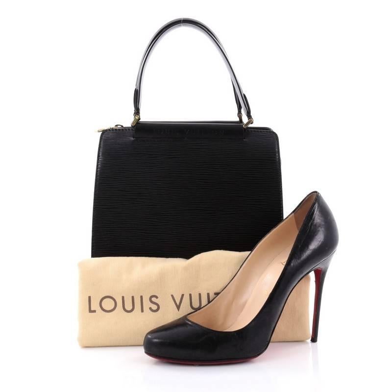 This authentic Louis Vuitton Figari Handbag Epi Leather PM is a classic piece made for LV lovers. Crafted in black epi leather, this structured bag features smooth black leather trims, dual leather handles, protective feet, embossed logo lettering
