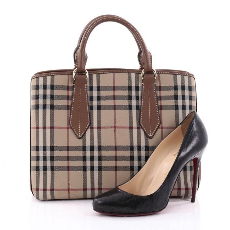 This authentic Burberry Ballingdon Tote Horseferry Check Canvas and Leather Medium is a stunning blend of classic Burberry with updated features. Crafted in Horseferry Check Canvas with brown leather trims, this tote features dual-rolled leather