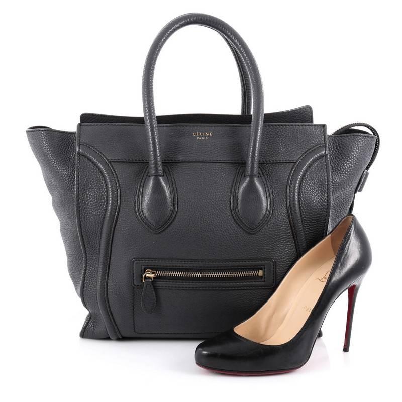 This authentic Celine Luggage Handbag Grainy Leather Mini epitomizes Phoebe Philo's minimalist yet chic style. Constructed in dark gray grainy leather, this beloved fashionista's bag features dual-rolled leather handles, a frontal zip pocket,