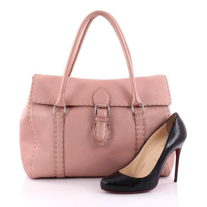 This authentic Fendi Linda Satchel Leather Large is a classic stylish bag perfect for daily or work excursions. Constructed from light pink metallic leather, this stylish satchel features dual-rolled leather handles, hand stitched saddle top
