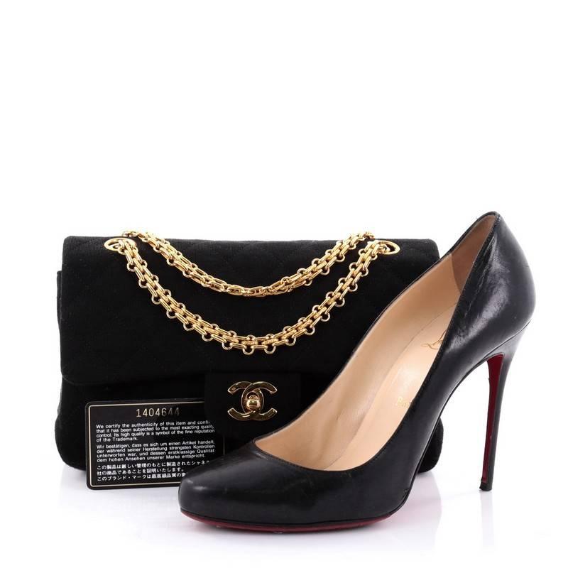 This authentic Chanel Bijoux Chain Double Flap Bag Quilted Jersey Small exudes a classic yet easy style made for the modern woman. Crafted in black jersey with Chanel's signature diamond quilting design, this elegant flap features iconic bijoux gold
