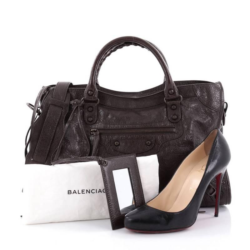 This authentic Balenciaga City Classic Studs Handbag Leather Medium is for the on-the-go fashionista. Constructed of brown leather, this popular bag features dual braided woven handle straps, front zip pocket, iconic Balenciaga classic studs and