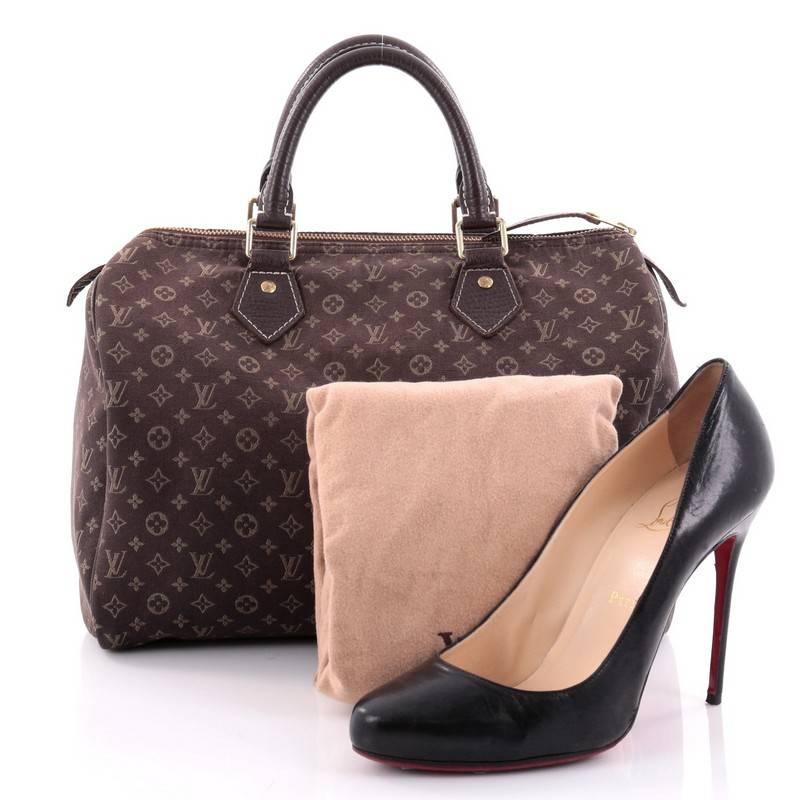 This authentic Louis Vuitton Speedy Handbag Mini Lin 30 is an elegant and playful update to the iconic Speedy bag. Crafted from Louis Vuitton's lightweight monogram mini lin canvas in ebene shade, this lightweight speedy features dark brown cowhide