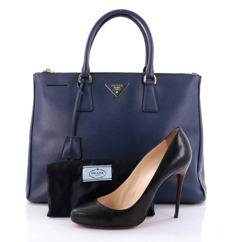 This authentic Prada Double Zip Lux Tote Saffiano Leather Large is the perfect bag to complete any outfit. Crafted from blue saffiano leather, this boxy tote features side snap buttons, raised Prada logo plate, dual-rolled leather handles and