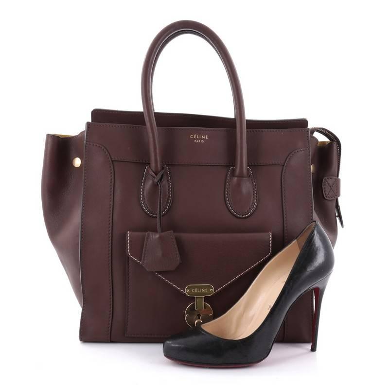 This authentic Celine Envelope Luggage Handbag Smooth Leather Mini is a wonderful size bag that lends a sophisticated chic look for travel or everyday. Crafted in brown smooth leather, this chic bag features dual-rolled leather handles, exterior