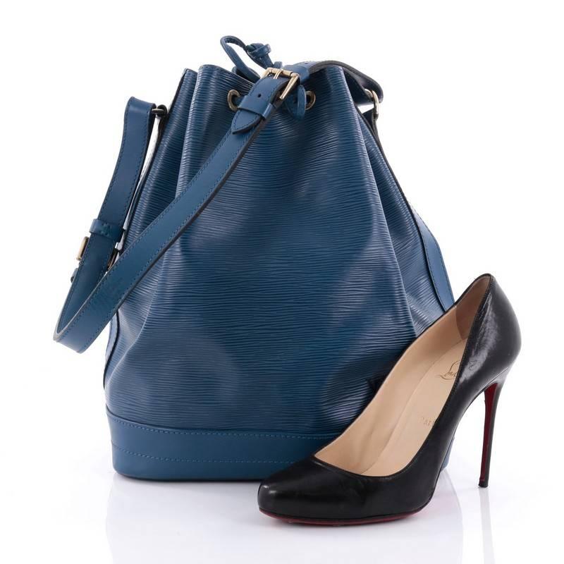 This authentic Louis Vuitton Noe Handbag Epi Leather Large is a chic and iconic bucket bag made for the modern fashionista. Crafted from blue epi leather, this bucket bag features adjustable shoulder strap, subtle LV logo, leather drawstring
