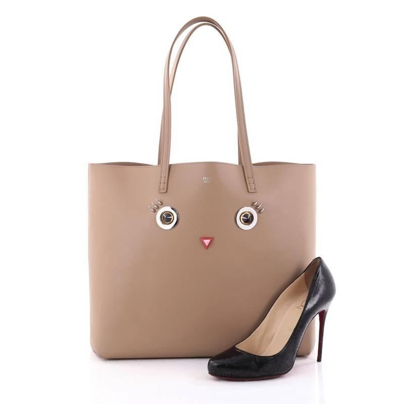 This authentic Fendi Faces Roll Tote Embellished Leather Large features a playfully striking detail elaborating the elegantly decadent spirit of the brand. Crafted from light brown leather with eyes and mouth embellishments, this chic tote features