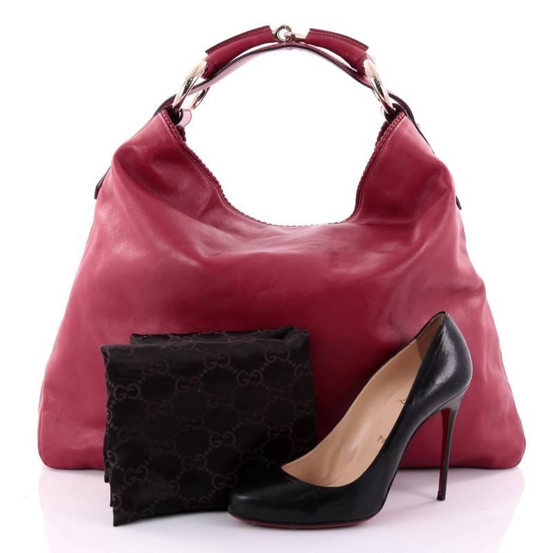 This authentic Gucci Horsebit Hobo Leather Large is an iconic design that adds a touch of elegance to your casual look. Crafted from smooth red leather, this no-fuss, easy-to-chic features a single looped handle, gold-tone hardware, and metal
