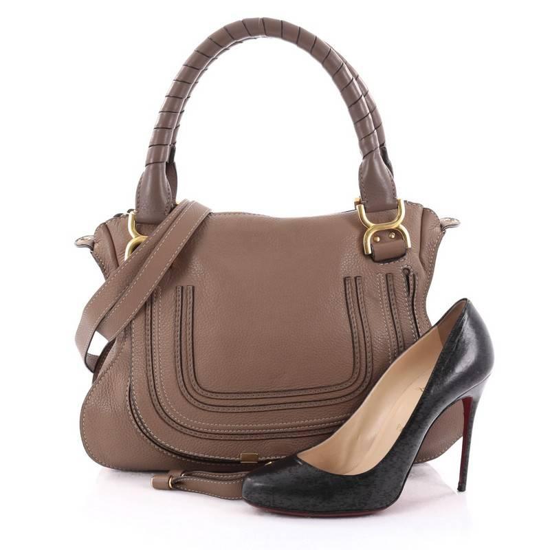 This authentic Chloe Marcie Satchel Leather Medium is perfect for the on-the-go fashionista. Constructed from light brown leather, this popular satchel features wrapped leather handles, horseshoe stitched front flap, and gold-tone hardware. Its top