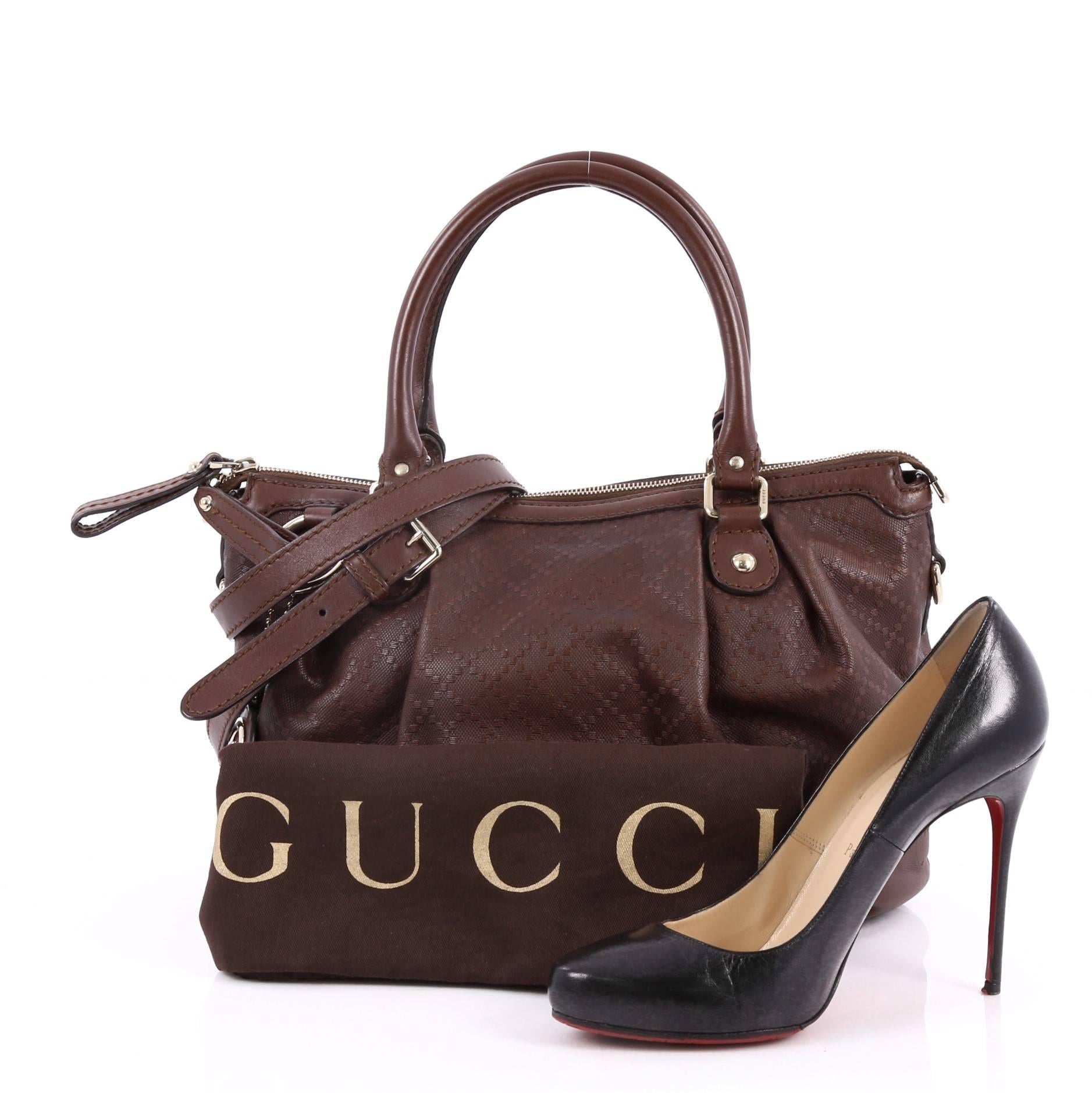 This authentic Gucci Sukey Top Handle Satchel Diamante Leather Medium is a chic tote ideal for everyday wear. Crafted from Gucci's brown diamante leather with leather trims, this roomy tote features a ruched design, dual-rolled handles and gold-tone