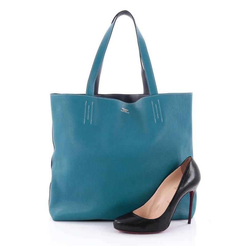 This authentic Hermes Double Sens Tote Clemence 45 combines simple style and functional design from Hermes perfect for everyday use. Crafted from soft luxurious Taurillon Clemence leather in blue izmir and blue sapphire, this reversible tote