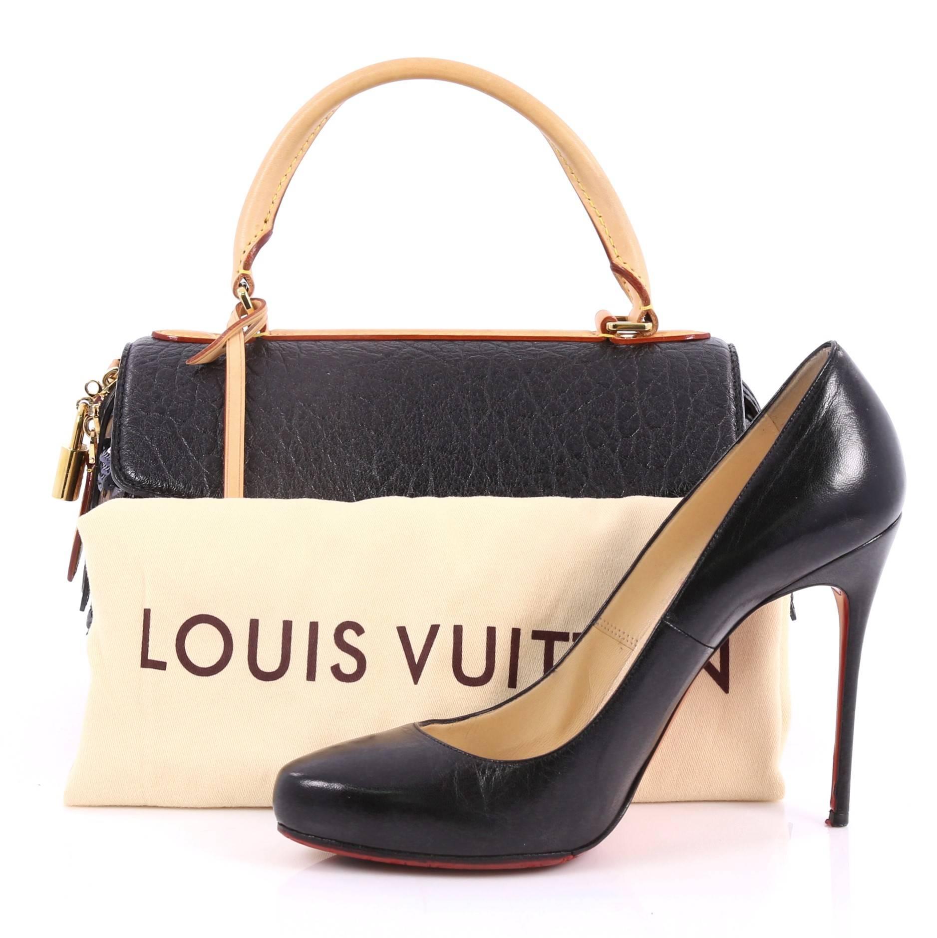 This authentic Louis Vuitton Carrousel Handbag Limited Edition Fleur De Jais presented in the brand's Fall/Winter 2010 Collection is a hard-to-find accessory perfect to add to your collection. Crafted from brown monogram coated canvas, this top