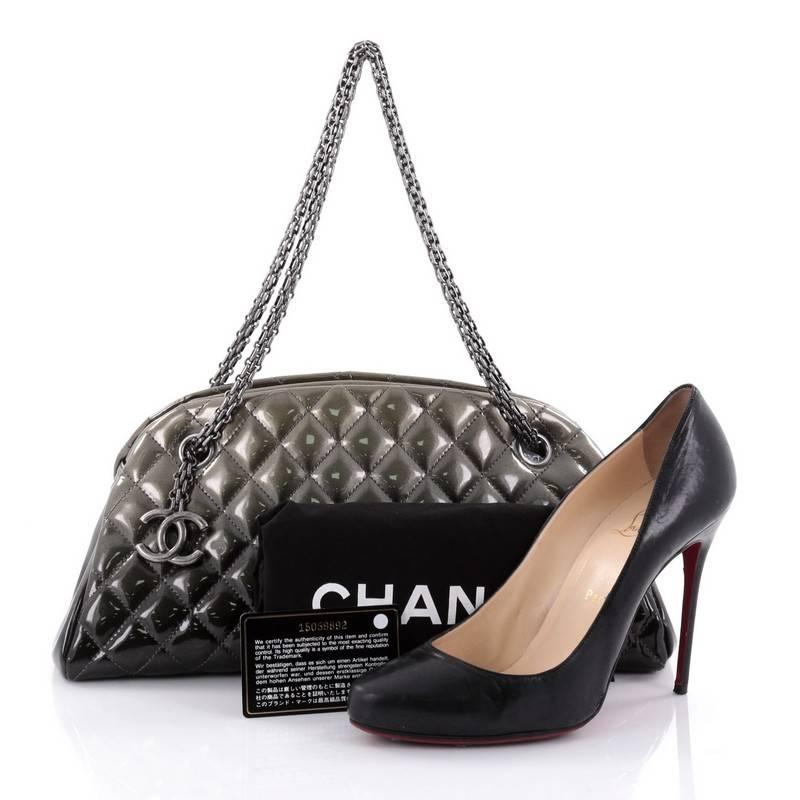 This authentic Chanel Just Mademoiselle Degrade Handbag Quilted Patent Medium showcases a sleek style that complements any look. Crafted from ombre effect olive green patent leather in Chanel's iconic diamond quilt pattern, this bag features Chanel
