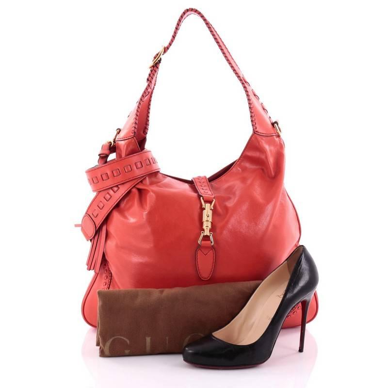 This authentic Gucci New Jackie Handbag Leather Large is a must-have luxurious everyday hobo fit for the modern woman. Constructed from supple red orange leather, this bag features adjustable buckle shoulder strap with whipstitch detailing, side