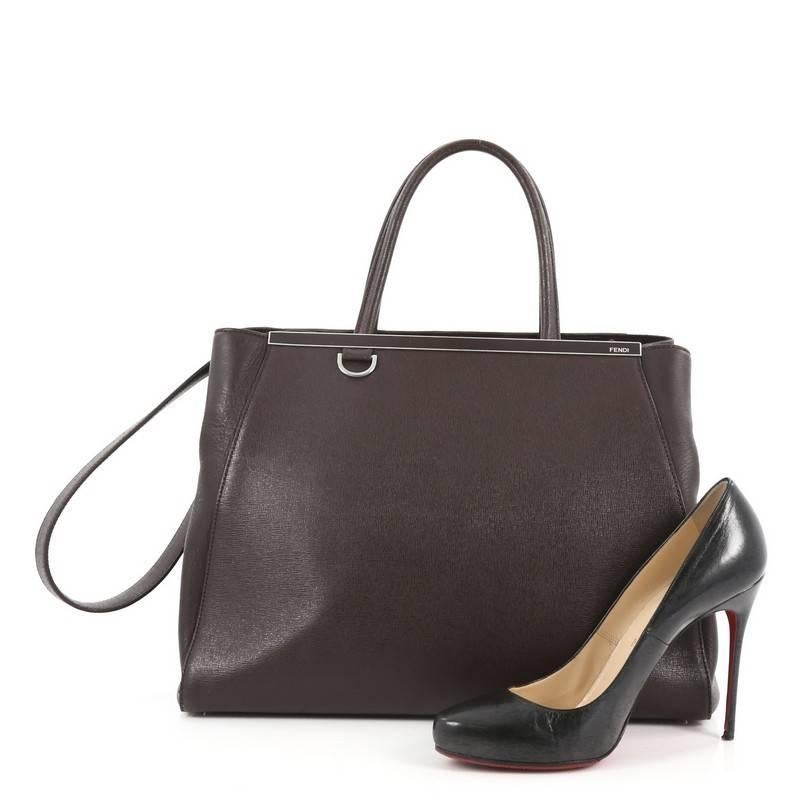 This authentic Fendi 2Jours Handbag Leather Medium is impeccably stylish with a simple silhouette and structured design. Finely crafted in sturdy dark brown leather with soft calfskin sides, this popular tote features a shining top bar that dons the