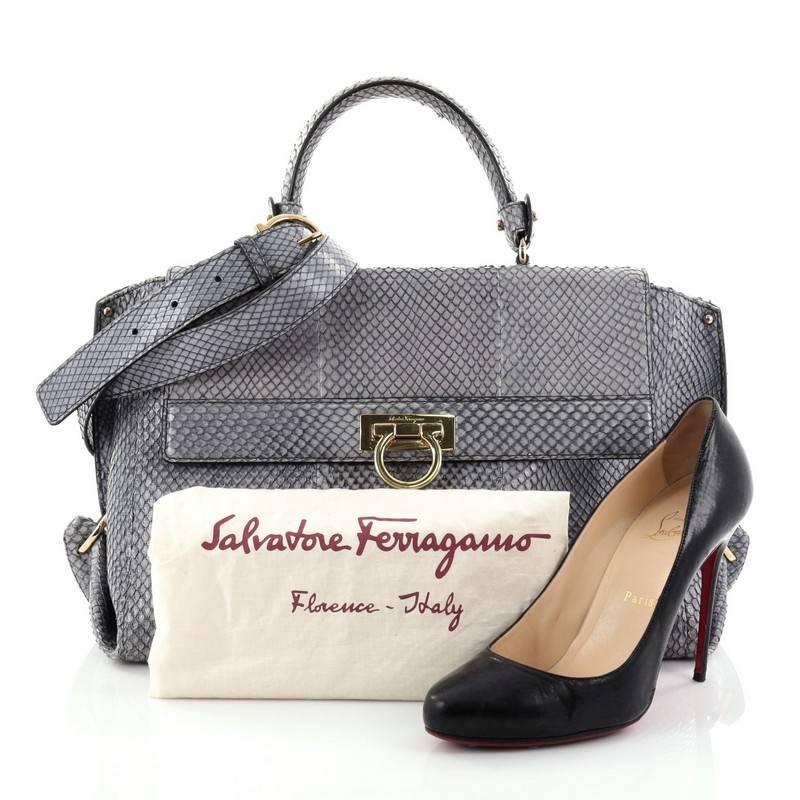 This authentic Salvatore Ferragamo Sofia Satchel Python Medium is a stylish and functional, chic bag perfect for the modern woman. Crafted in genuine grayish blue python skin, this bag features a single rolled python skin handle, exterior back zip