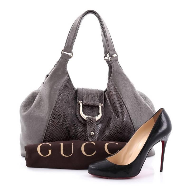 This authentic Gucci Greenwich Shoulder Bag Leather and Python Medium in a sturdy, industrial design is ideal for all seasons. Crafted from taupe leather and genuine python skin, this chic hobo-style shoulder bag features dual-flat handles, sides