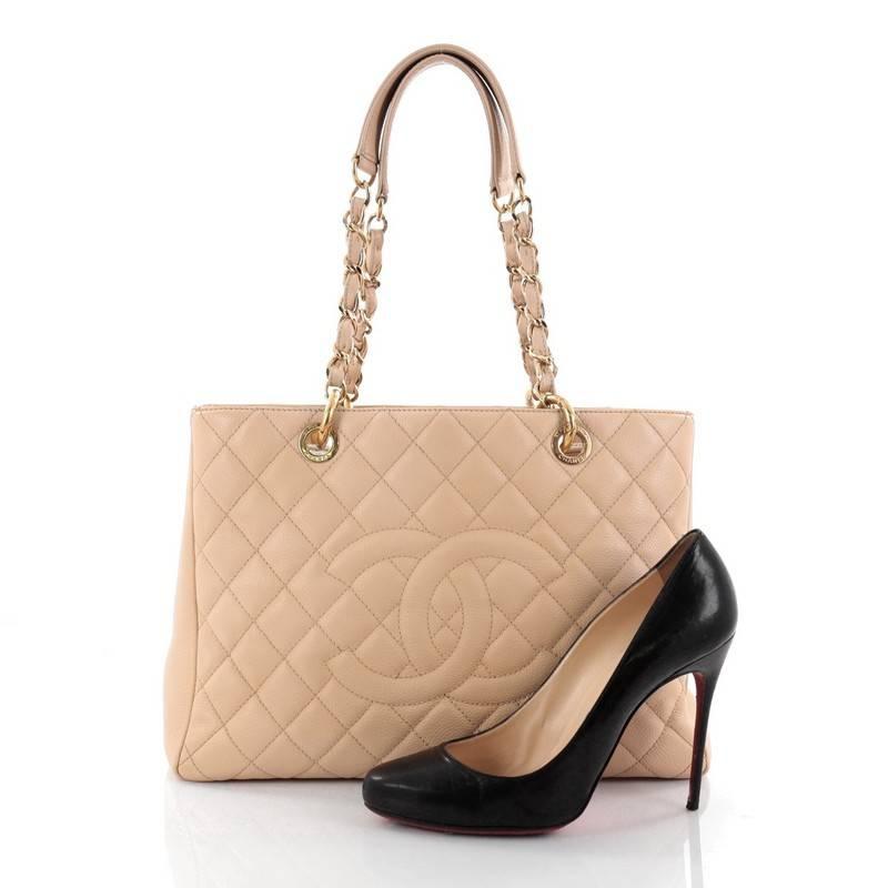 This authentic Chanel Grand Shopping Tote Quilted Caviar is perfect for everyday use with a classic yet luxurious style. Crafted in beige diamond quilted caviar leather, this versatile, timeless tote features a stitched CC in the middle, woven-in