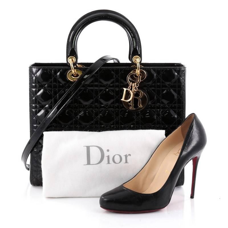 This authentic Christian Dior Lady Dior Handbag Cannage Quilt Patent Large is a classic staple that every fashionista needs in her wardrobe. Crafted from black patent leather in Dior's iconic cannage quilting, this boxy bag features dual-rolled