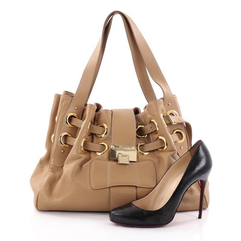 This authentic Jimmy Choo Ramona Hobo Leather is sophisticated and easy-to-carry made for everyday excursions. Constructed from supple beige leather, this hobo features multiple wrapped slim leather straps laced through metal eyelets, dual flat