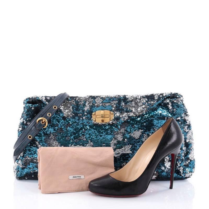 This authentic Miu Miu Convertible Flap Bag Sequin Embellished Leather Large is sophisticated in design, perfect for your nights out. Crafted in blue and silver sequin embellished leather, this flap bag features an adjustable detachable strap,