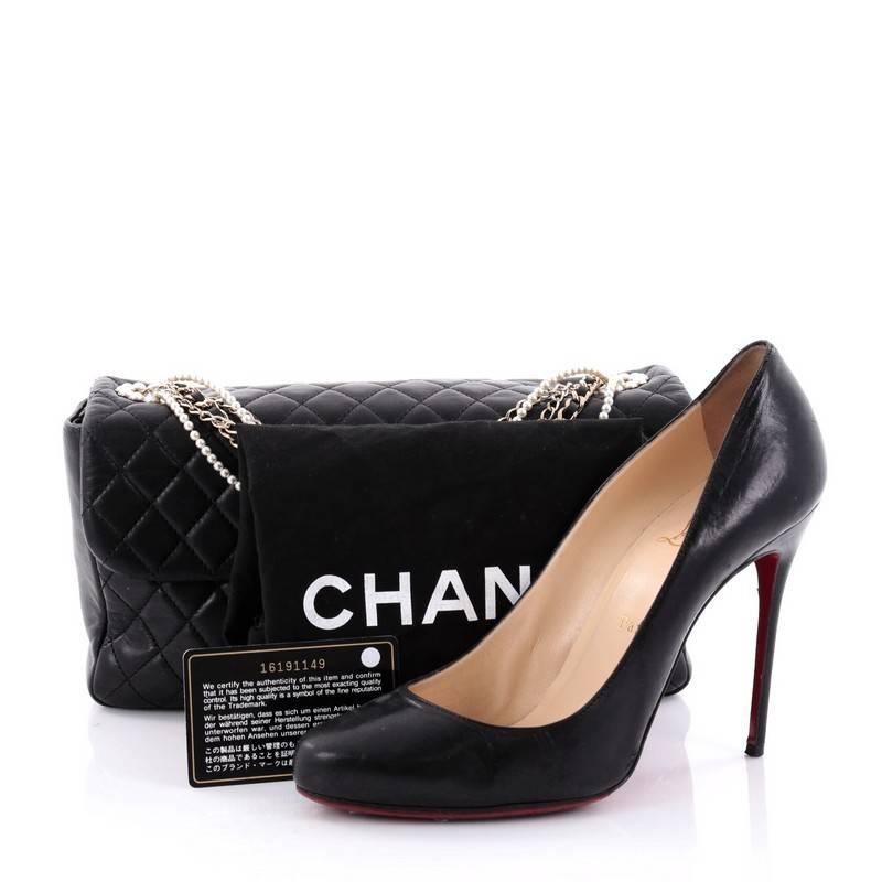 This authentic Chanel Westminster Pearl Chain Flap Bag Quilted Lambskin Medium exudes a classic yet easy style made for the modern woman. Crafted from black lambskin leather, this elegant flap features Chanel's signature diamond quilted design,
