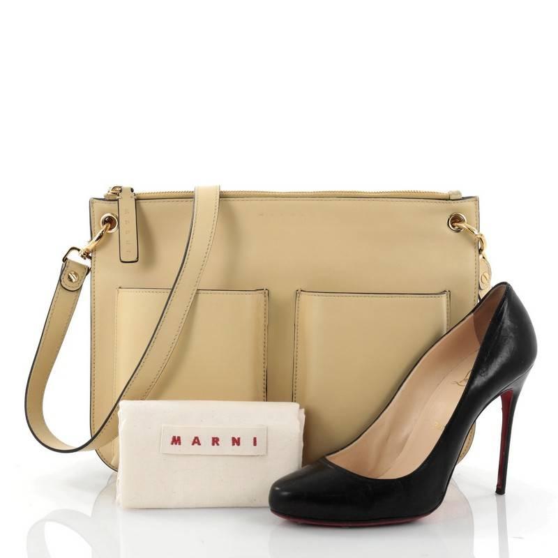 This authentic Marni Bandoleer Crossbody Bag Leather Medium is a practical and easy bag perfect for your everyday use. Crafted in pale yellow leather, this bag features adjustable crossbody strap, exterior patch pockets, a front embossed logo stamp