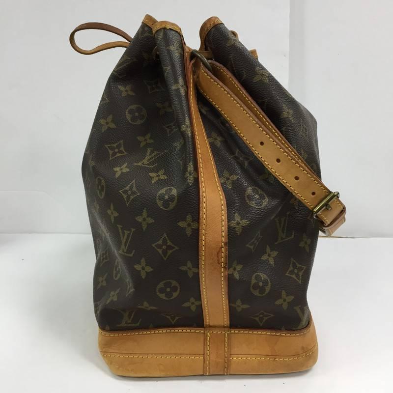 This authentic Louis Vuitton Noe Handbag Monogram Canvas Large dates back to one of Louis Vuitton's most iconic pieces alongside the Keepall and Speedy. The signature brown monogram coated canvas is designed into a bucket silhouette that can be