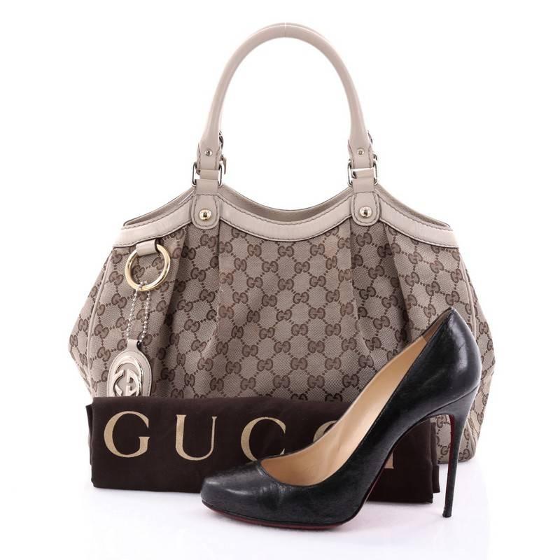 This authentic Gucci Sukey Tote GG Canvas Medium is perfect for any casual or sophisticated outfit. Constructed from Gucci's khaki GG monogram canvas with off-white leather trims, this roomy tote features dual-rolled leather handles that sit