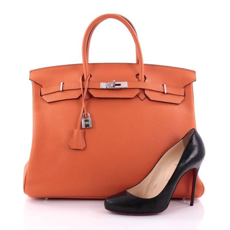 This authentic Hermes Birkin Handbag Orange Clemence with Palladium Hardware 40 is synonymous to traditional Hermes luxury. Crafted with sturdy, scratch-resistant orange clemence leather, this eye-catching luxurious tote is accented with polished