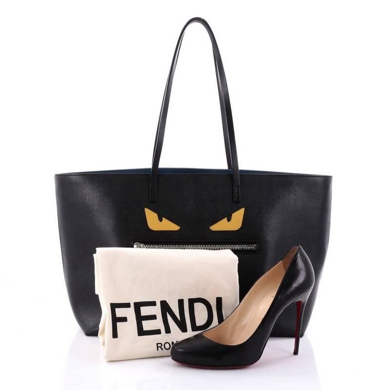 This authentic Fendi Monster Roll Tote Leather Medium is a uniquely, kitschy tote perfect for everyday looks. Crafted from black leather, this eye-catching, lightweight tote features dual slim leather straps, front zip pocket designed as the