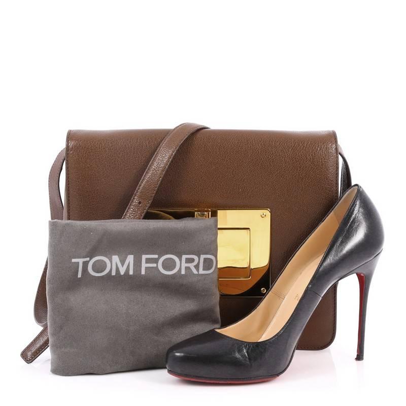 This authentic Tom Ford Natalia Convertible Clutch Leather Large redefines modern luxury with timeless elegance. Crafted from brown leather, this chic clutch features flat leather shoulder strap, exterior back slip pocket, and gold-tone hardware