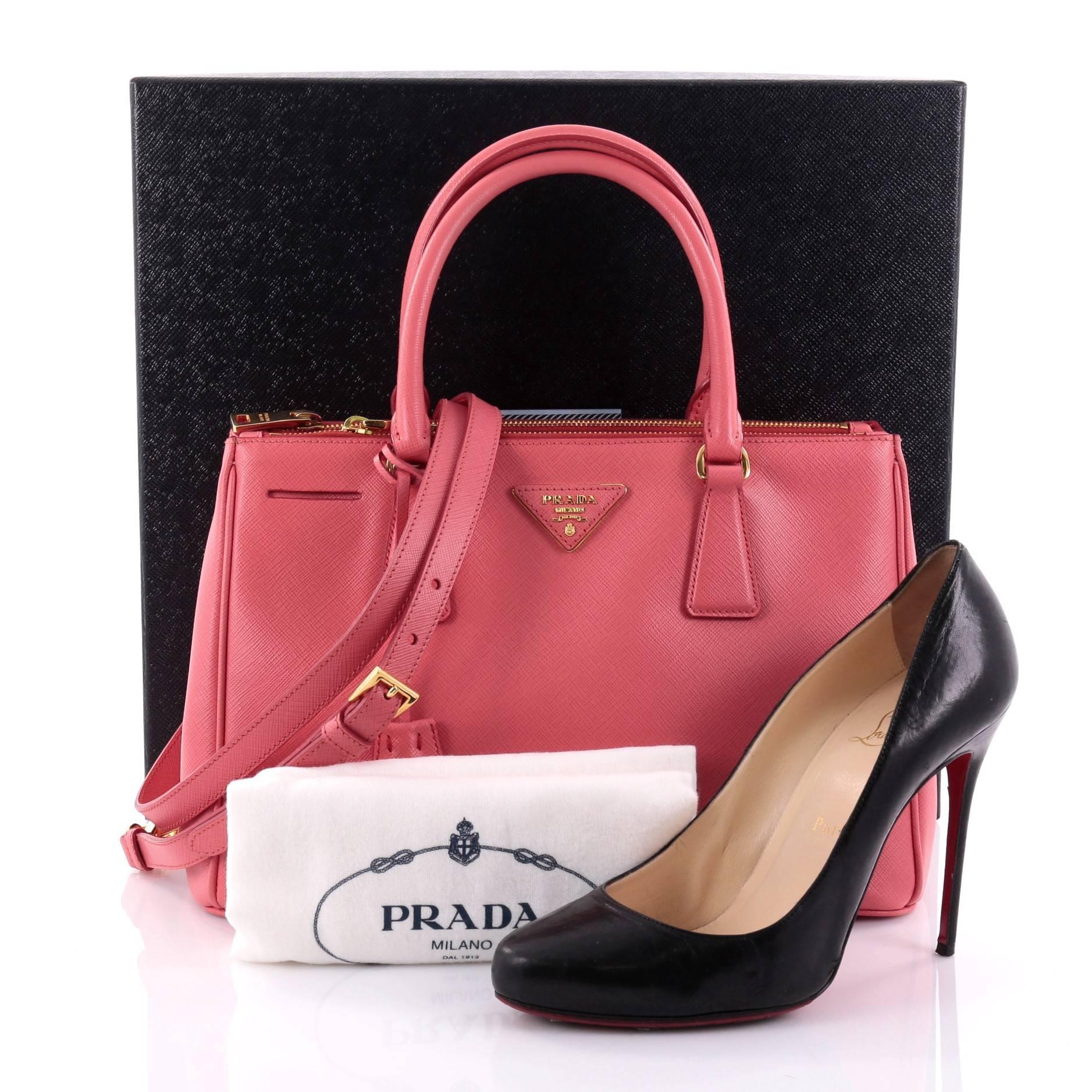 This authentic Prada Double Zip Lux Tote Saffiano Leather Medium is the perfect bag to complete any outfit. Crafted from pink saffiano leather, this boxy tote features side snap buttons, raised Prada logo, dual-rolled leather handles and gold-tone