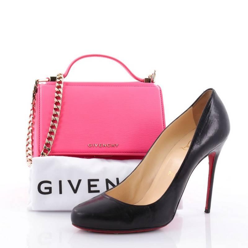 This authentic Givenchy Chain Pandora Box Handbag Leather Mini is the perfect companion for any on-the-go fashionista. Crafted from hot pink leather, this edgy and cult-favorite miniature satchel features a pandora box-inspired silhouette, a