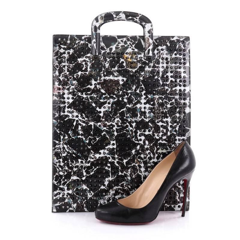 This authentic Christian Louboutin Trictrac Portfolio Bag Printed Spiked Leather Large is a unique and edgy bag perfect for the modern fashionista. Crafted in black and light grey marble-print leather with multi-spiked front, this bag features a