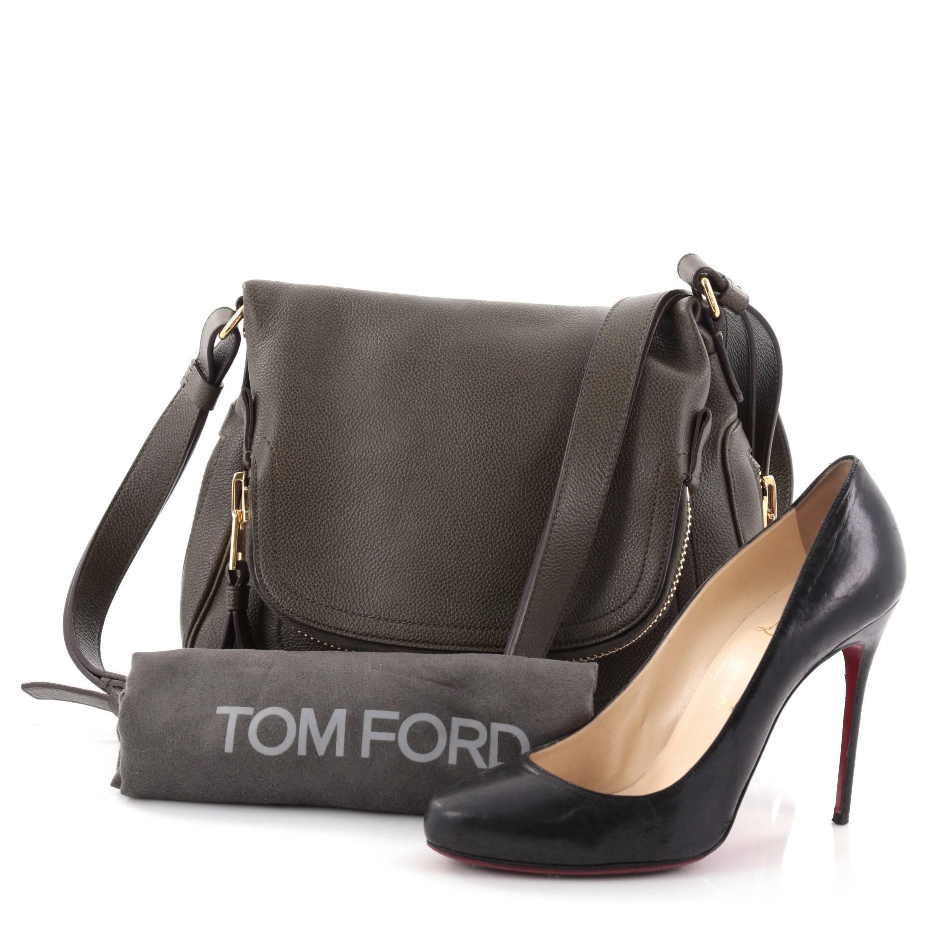 This authentic Tom Ford Jennifer Crossbody Bag Leather Medium redefines modern luxury with timeless elegance. Crafted in olive green leather, this signature saddle shoulder bag features an adjustable crossbody strap, zip-top fold-over flap,