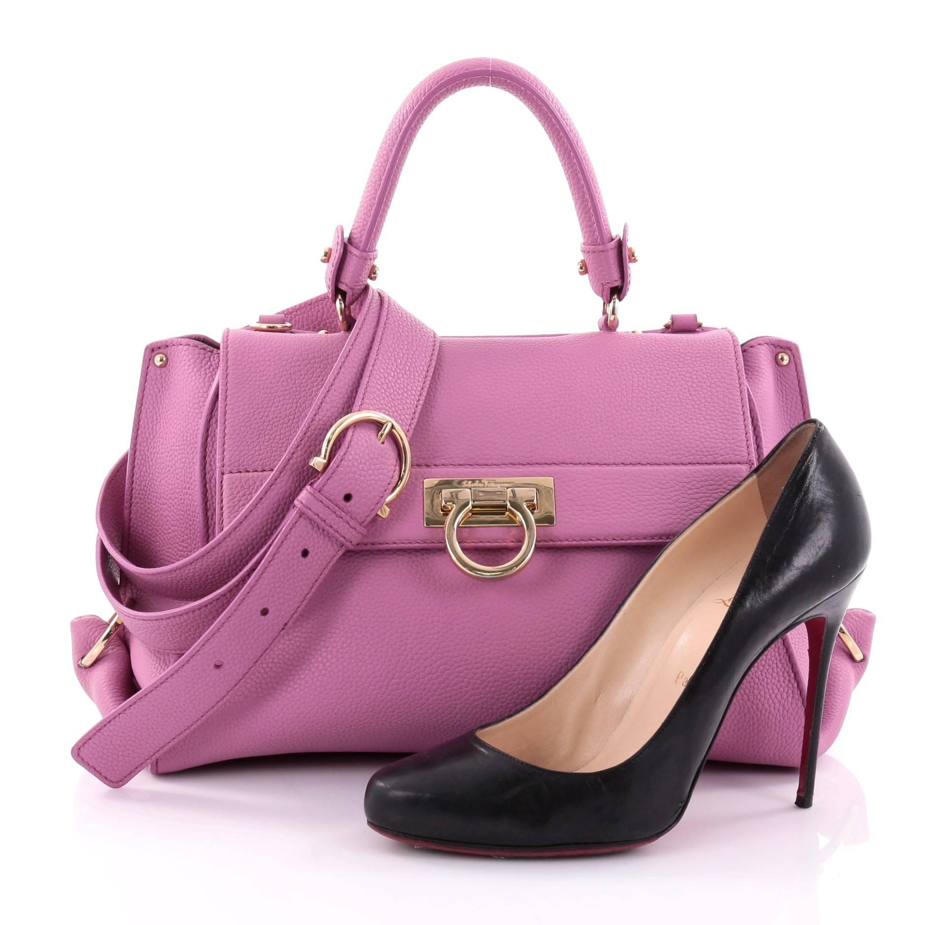 This authentic Salvatore Ferragamo Sofia Satchel Pebbled Leather Medium is a stylish and functional bag perfect for the modern woman. Crafted in pink pebbled leather, this bag features rolled leather handle, protective base studs, exterior back zip