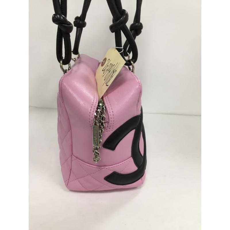 This authentic Chanel Cambon Bowler Bag Quilted Leather Medium is a chic and stylish bag from the brand's Cambon collection and is very popular among Chanel lovers everywhere. Crafted from pink diamond quilted leather, this handbag features a large