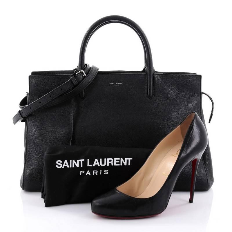 This authentic Saint Laurent Rive Gauche Cabas Leather Medium is a sleek yet elegant bag synonymous with the brand's classic aesthetic. Crafted from black leather, this sought-out tote features a Saint Laurent stamp signature at the front,