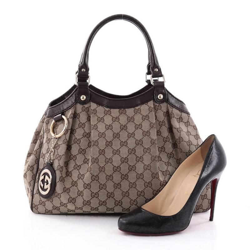 This authentic Gucci Sukey Tote GG Canvas Medium is perfect for any casual or sophisticated outfit. Constructed from Gucci's brown GG monogram canvas with dark brown leather trims, this roomy tote features dual-rolled leather handles that sit
