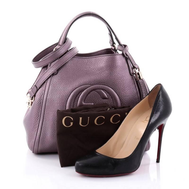 This authentic Gucci Soho Convertible Shoulder Bag Leather Small is a fresh, casual-chic tote made for everyday excursions. Crafted from metallic purple leather, this no-fuss tote features Gucci's signature interlocking GG logo stitched at the