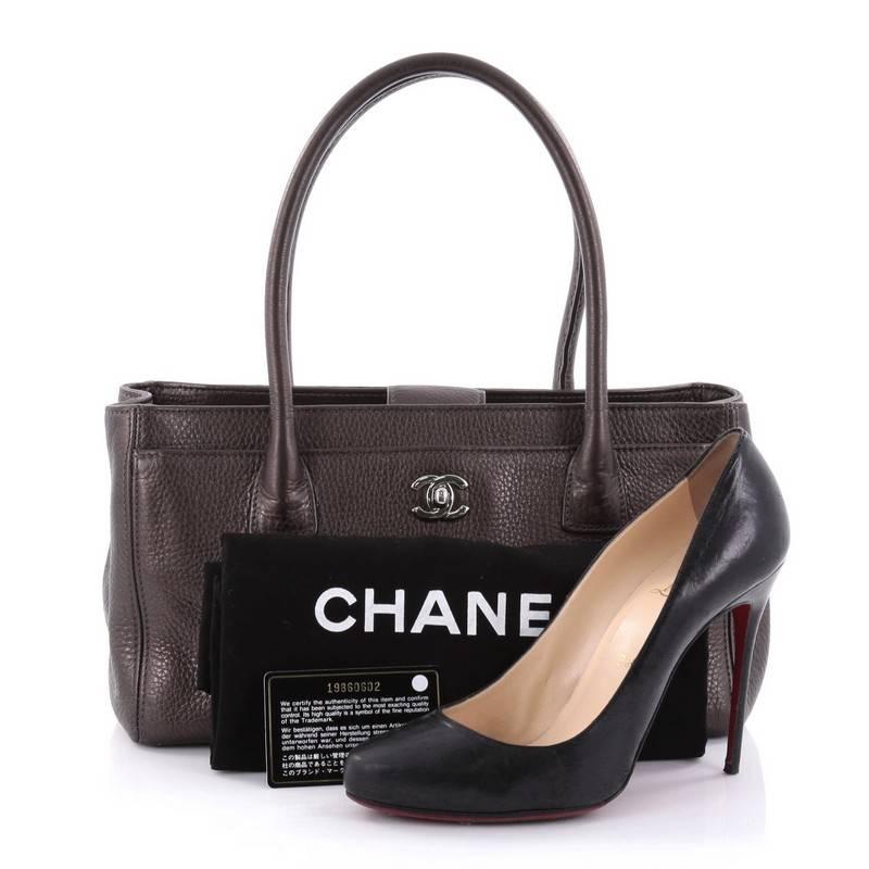 This authentic Chanel Cerf Executive Tote Leather Small is an ideal everyday accessory for the modern woman. Crafted from classic pewter grey leather, this functional tote features dual-rolled tall handles, front pocket with CC turn-lock closure,