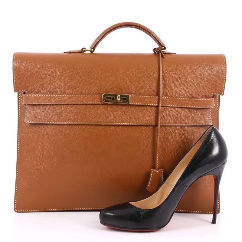 This authentic Hermes Kelly Depeche Handbag Courchevel 38 borrows its classic design from the brand's iconic Kelly bag. Crafted from sleek gold courchevel leather, this elegant, luxurious briefcase features a short rolled top handle, accordion-like